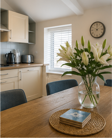 Holiday let dining table and kitchen prepared for guests